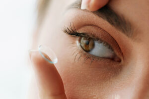Close up of an eye as person puts in contact lens in Chicago, IL